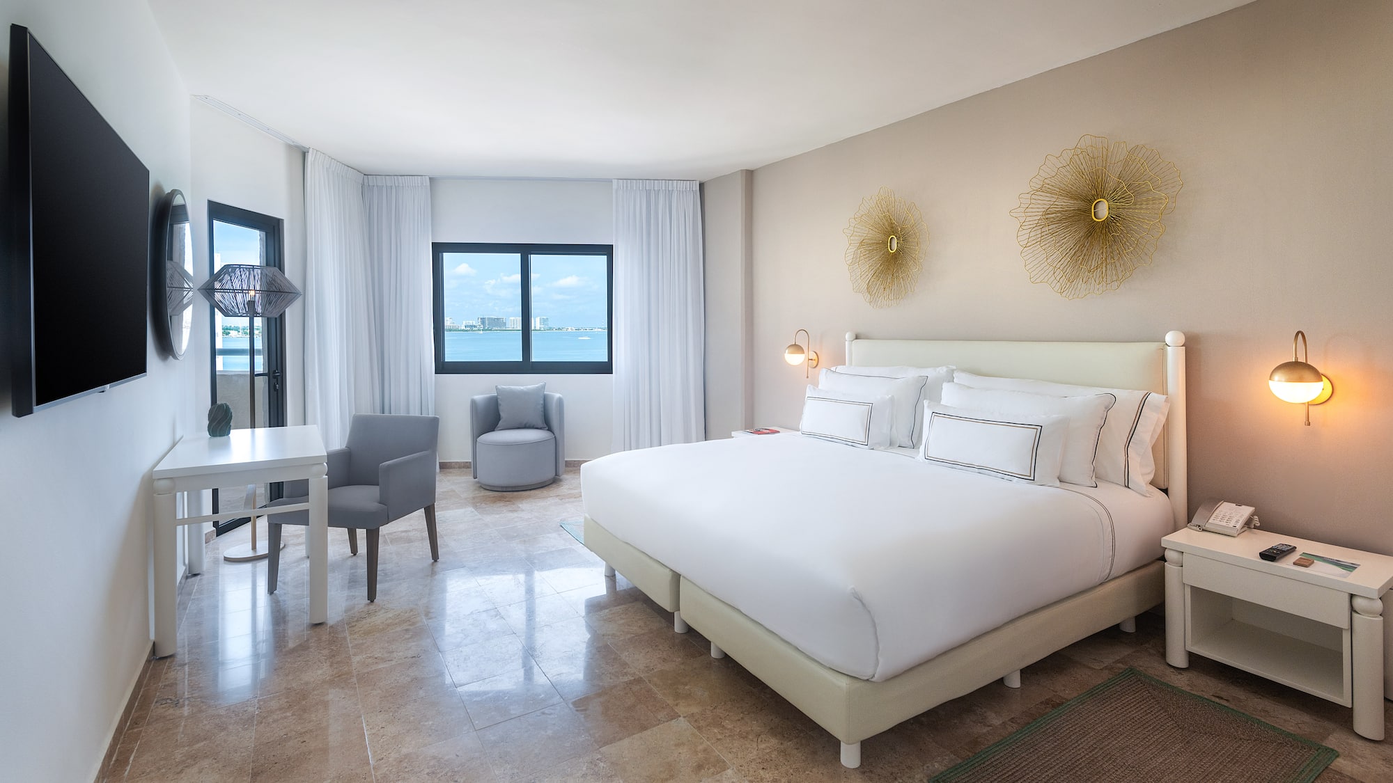 a room with a bed and a chair and a table