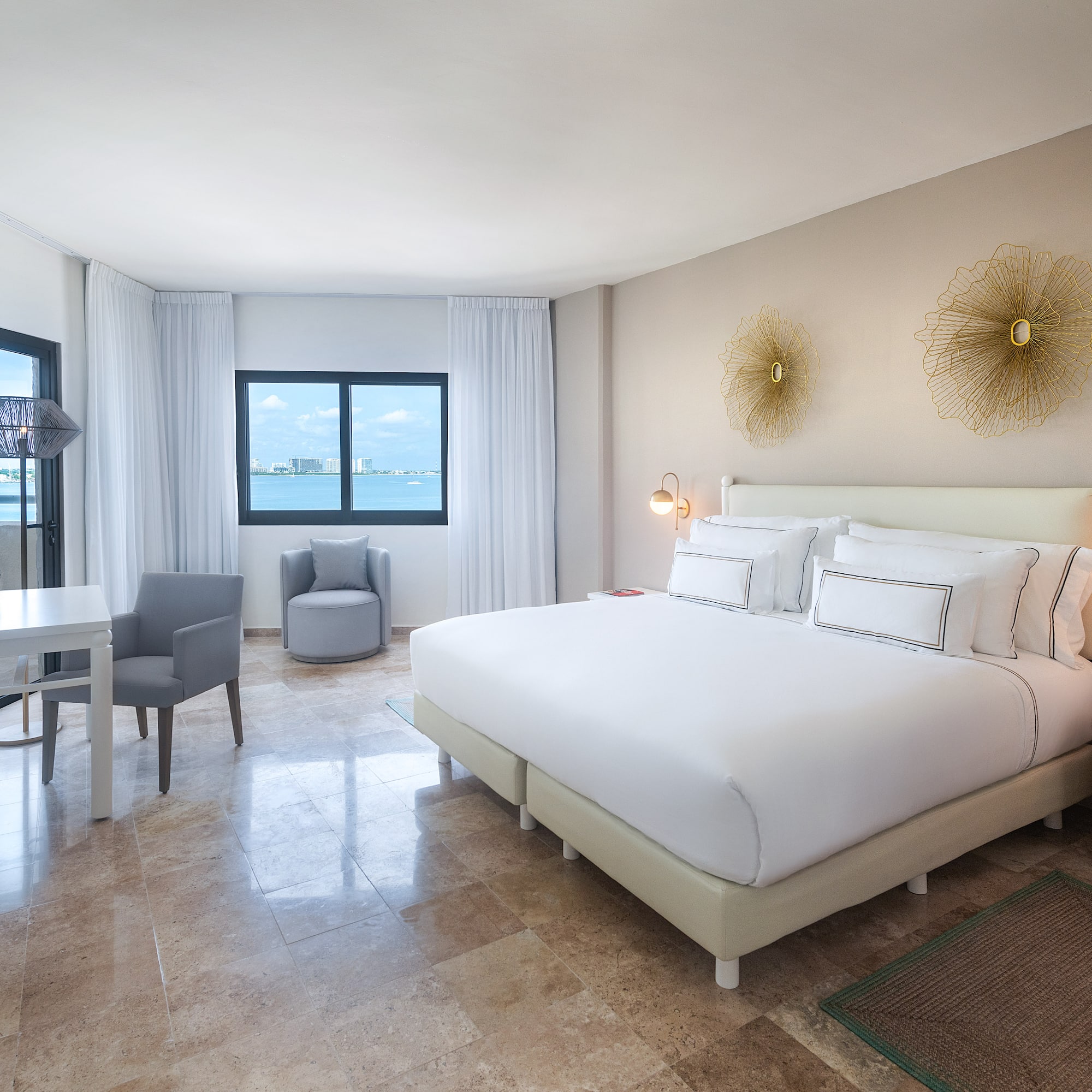 a room with a bed and a chair and a table