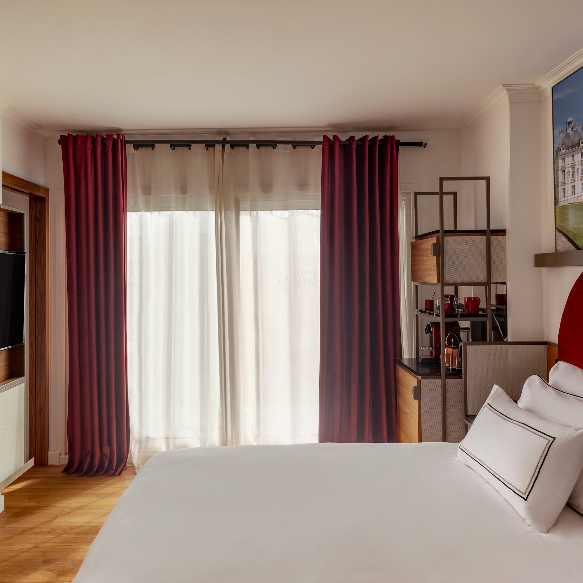 a bedroom with a bed and a television