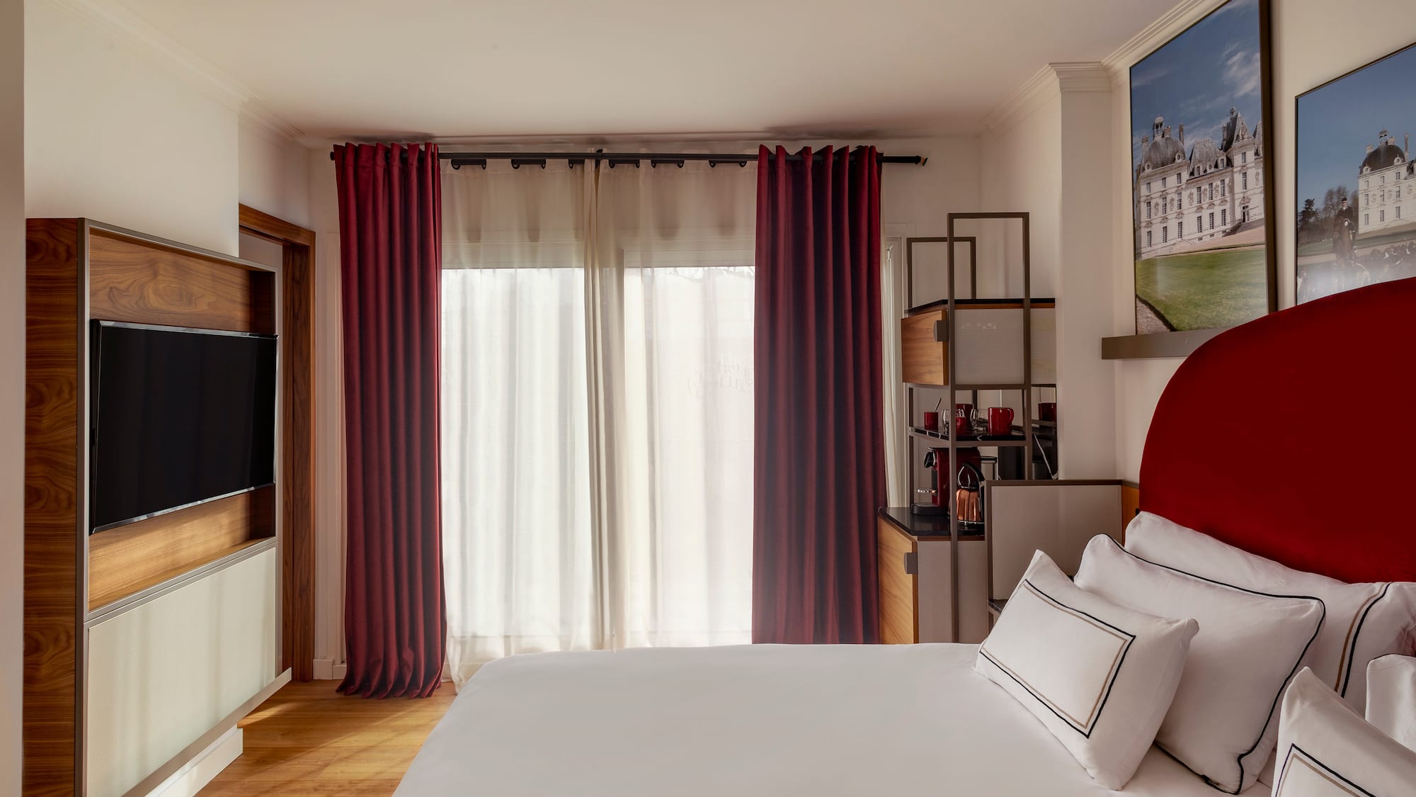 a bedroom with a bed and a television