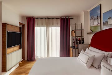 a bedroom with a bed and a television