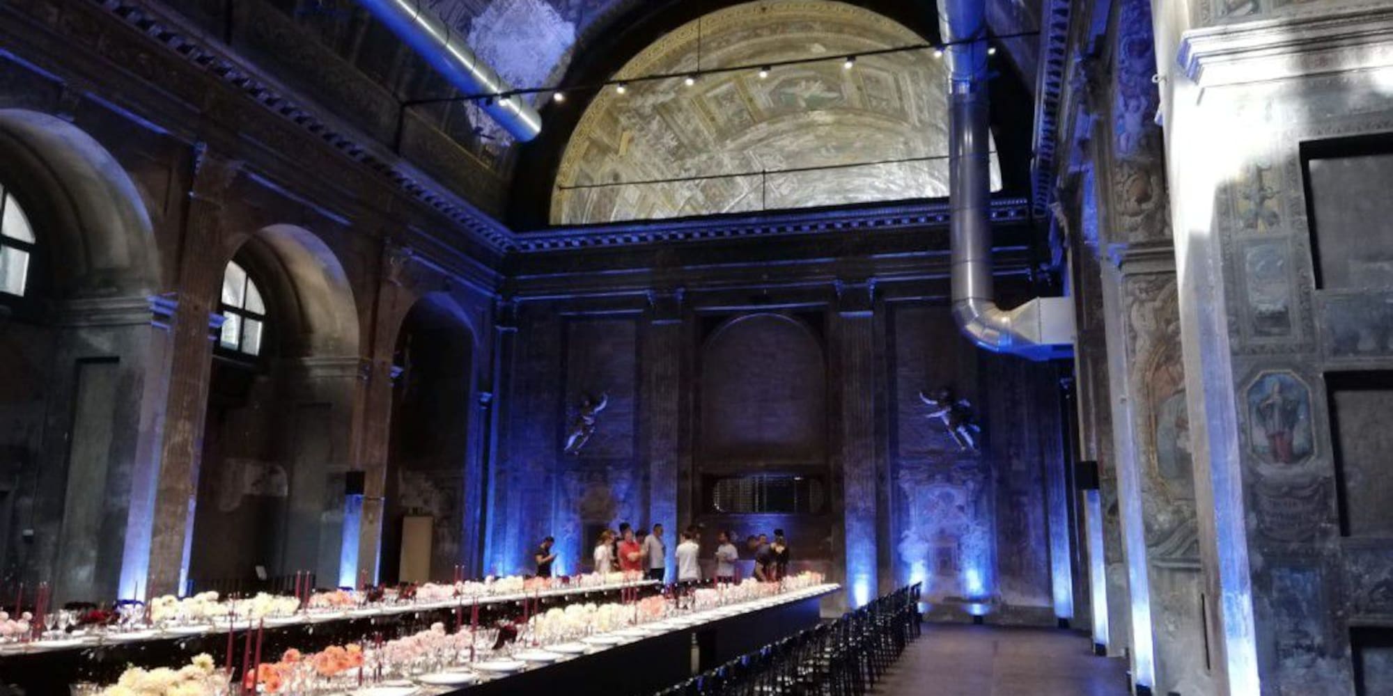 a long room with many tables and chairs