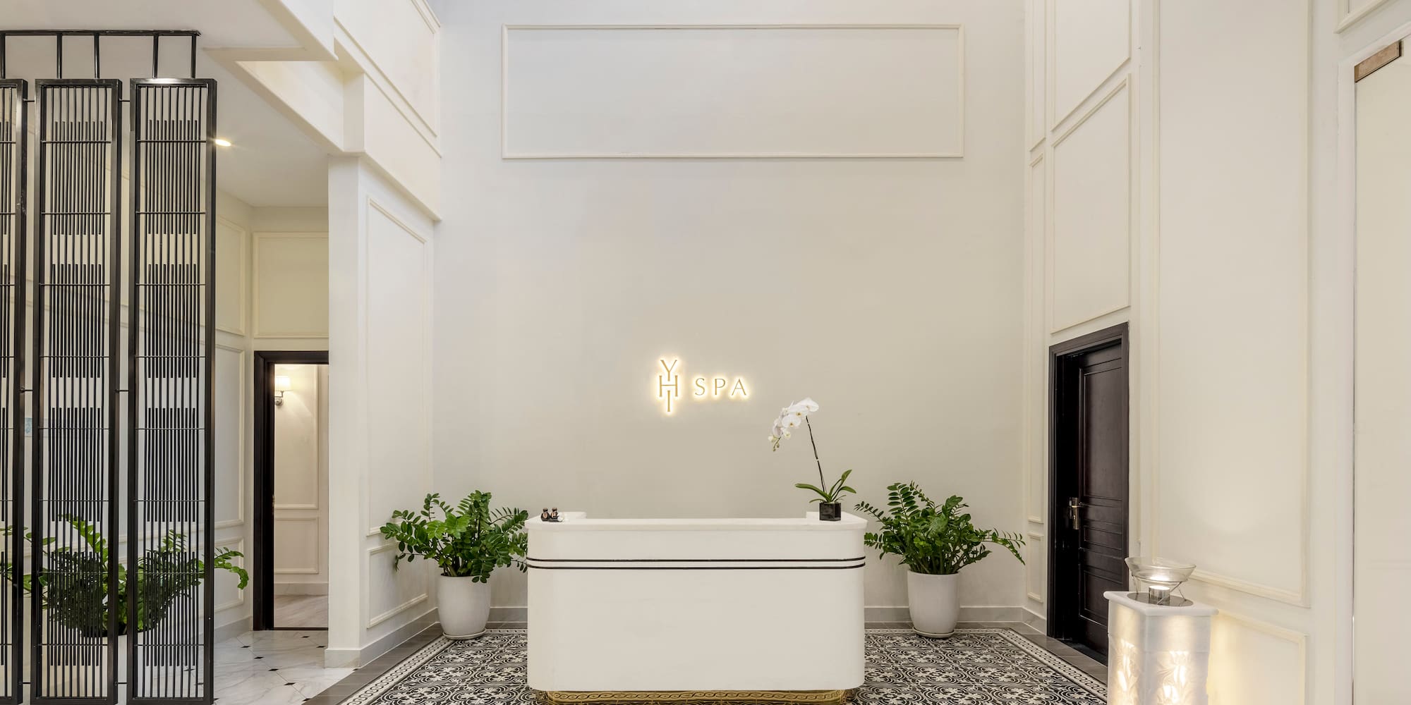 a white room with a bathtub and plants