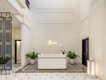 a white room with a bathtub and plants