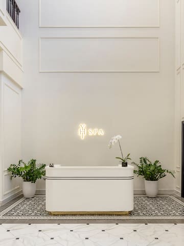 a white room with a bathtub and plants