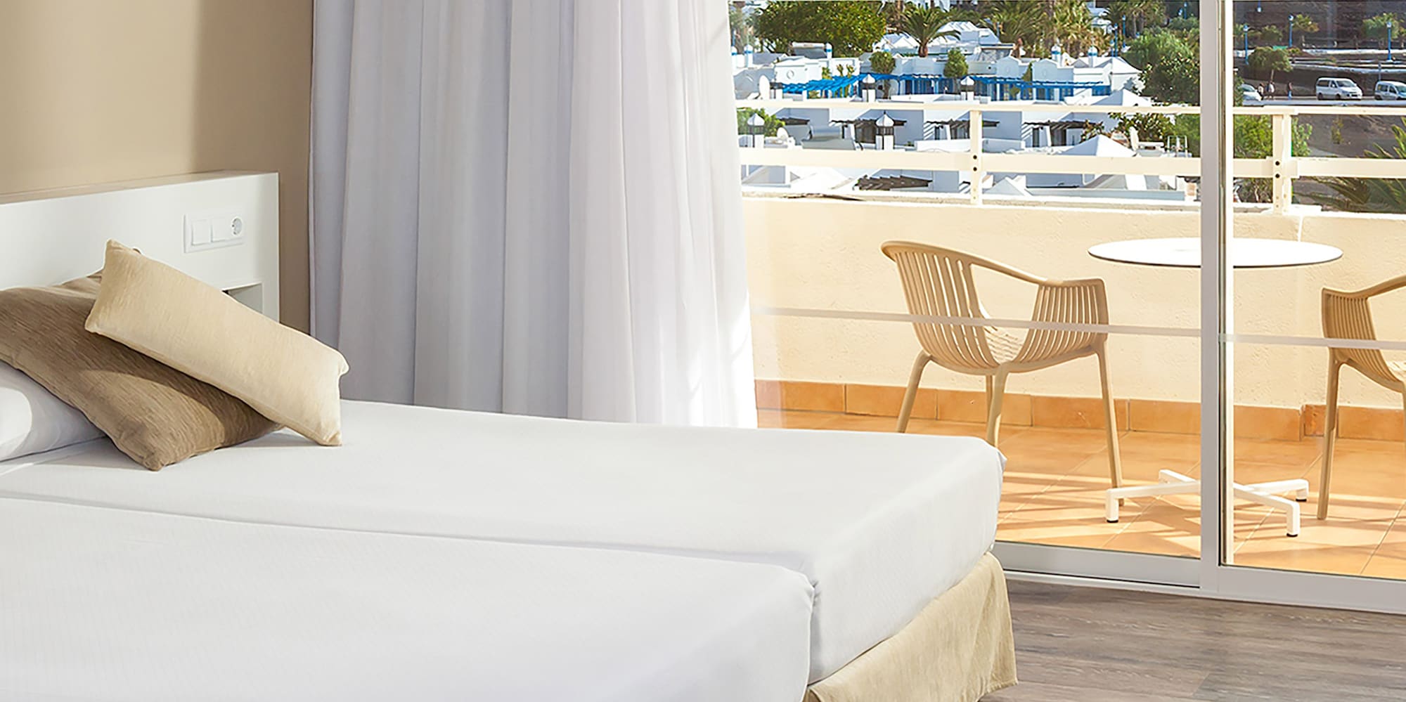 a hotel room with a view of the ocean and a balcony
