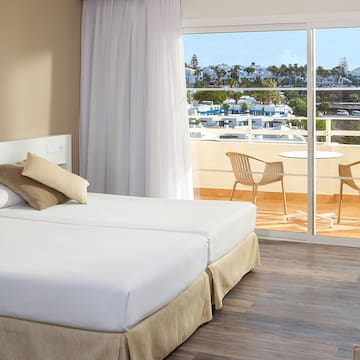 a hotel room with a view of the ocean and a balcony