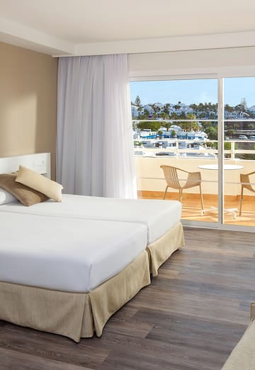a hotel room with a view of the ocean and a balcony