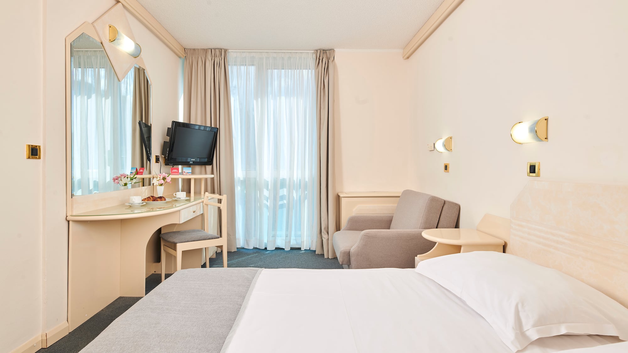 a room with a bed and a desk and chair