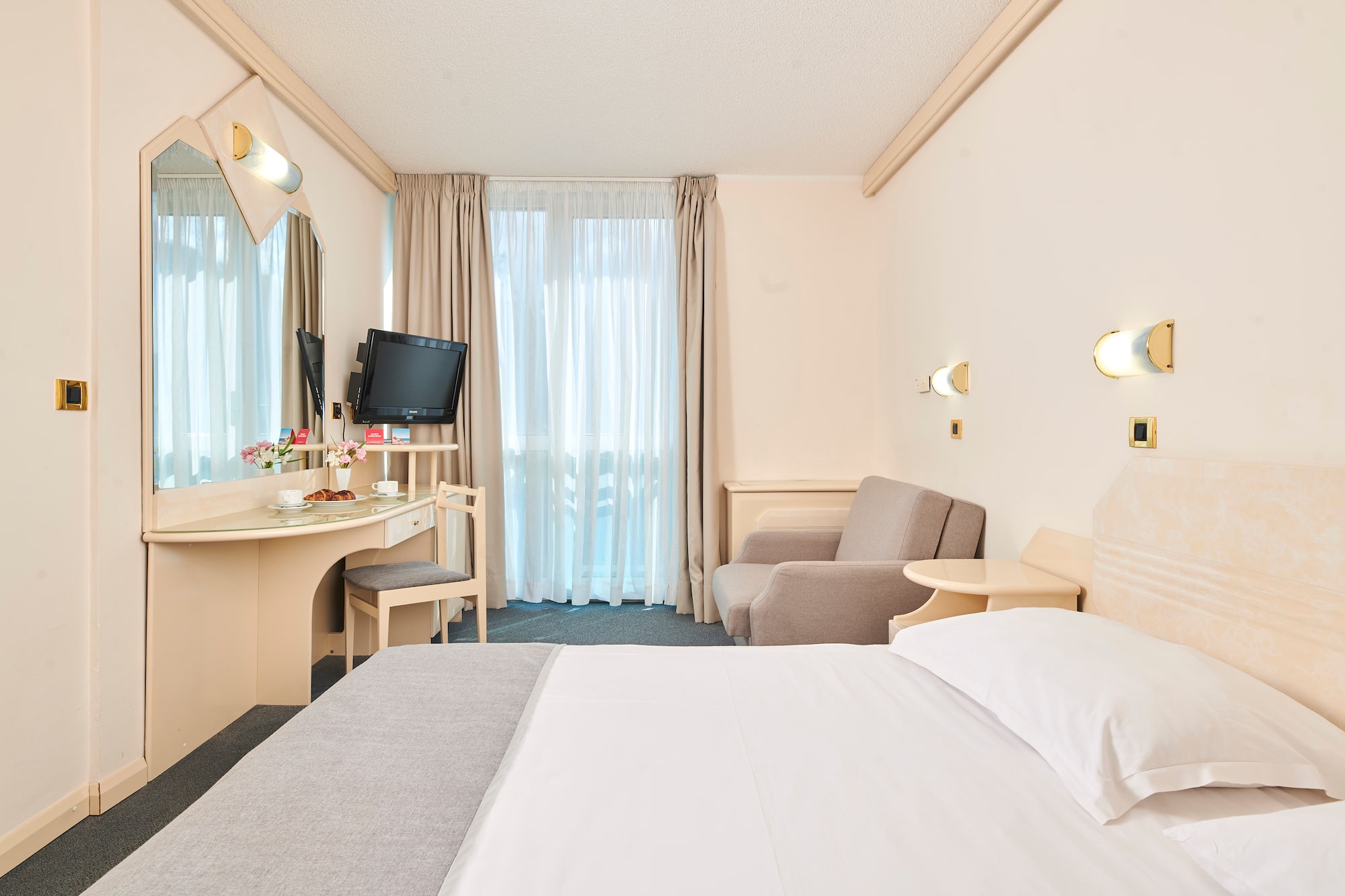 a room with a bed and a desk and chair