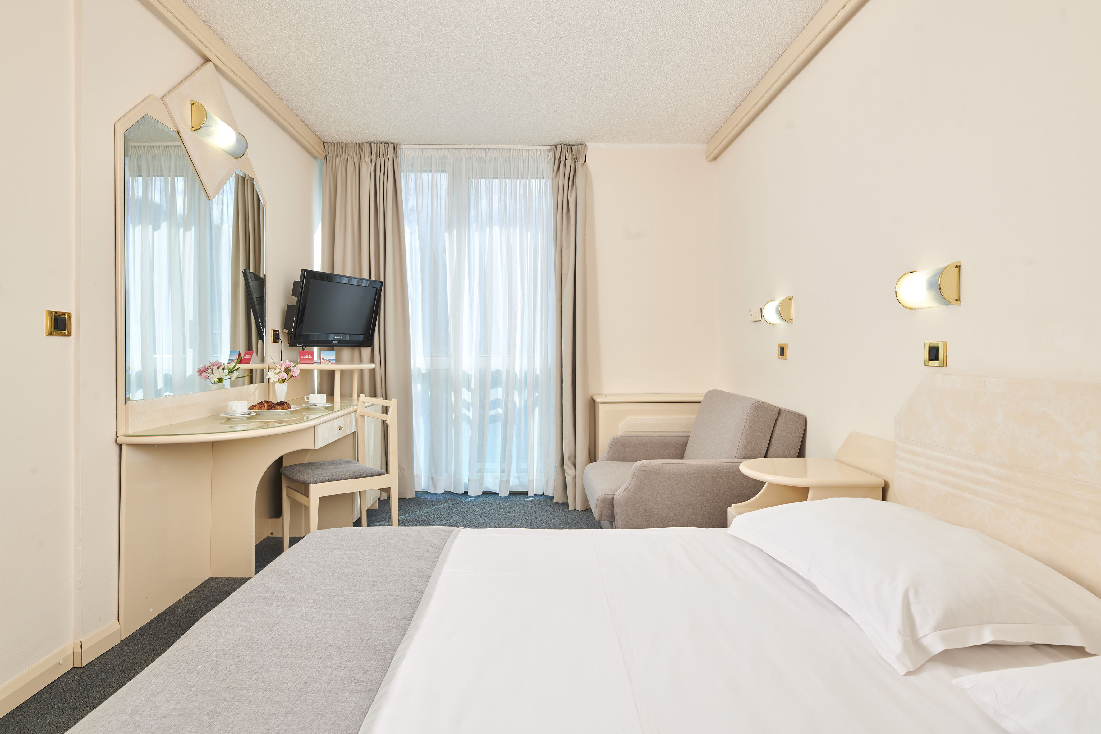 a room with a bed and a desk and chair