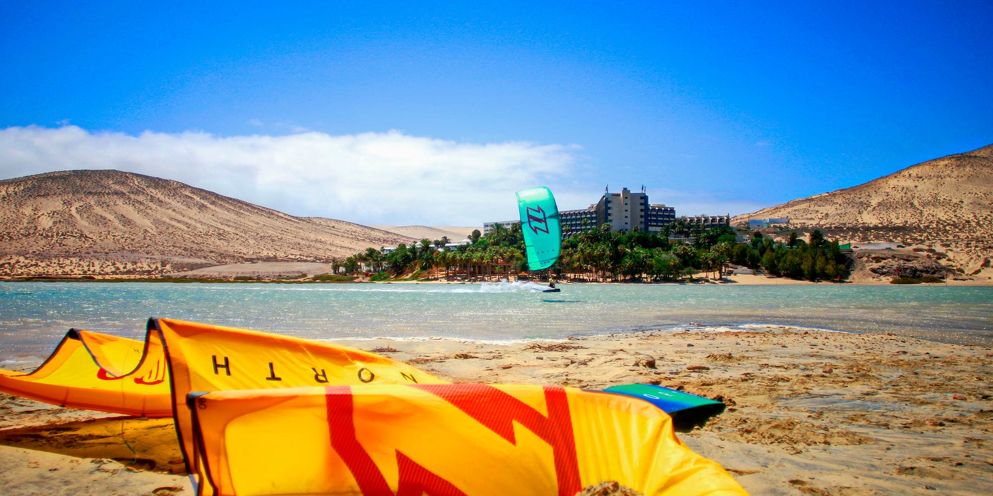 a yellow kite on a beach