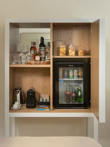 a cabinet with a mini fridge and drinks