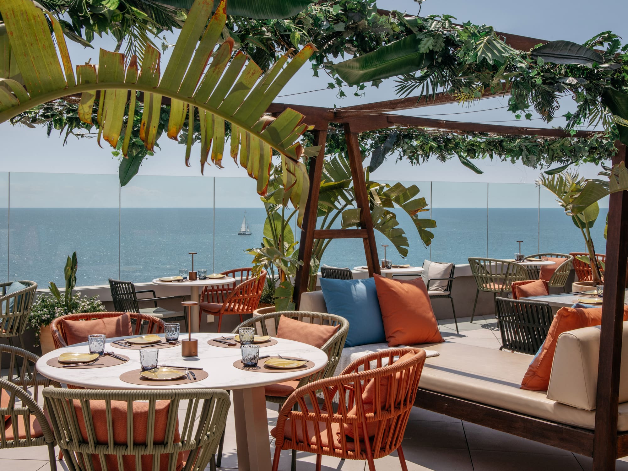 a table and chairs on a patio overlooking the ocean