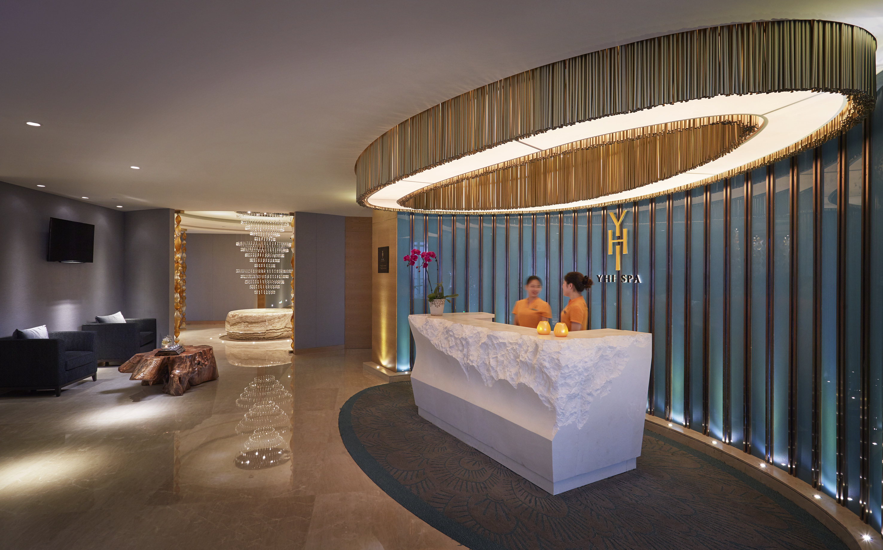 Luxury YHI Spa reception desk with two staff, elegant modern design.