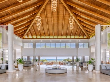 a large room with a large round table and chairs