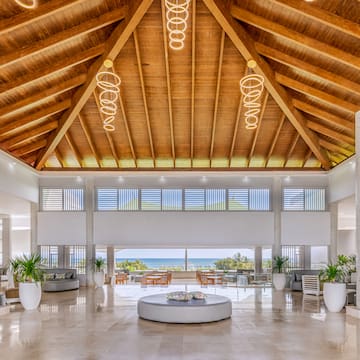 a large room with a large round table and chairs