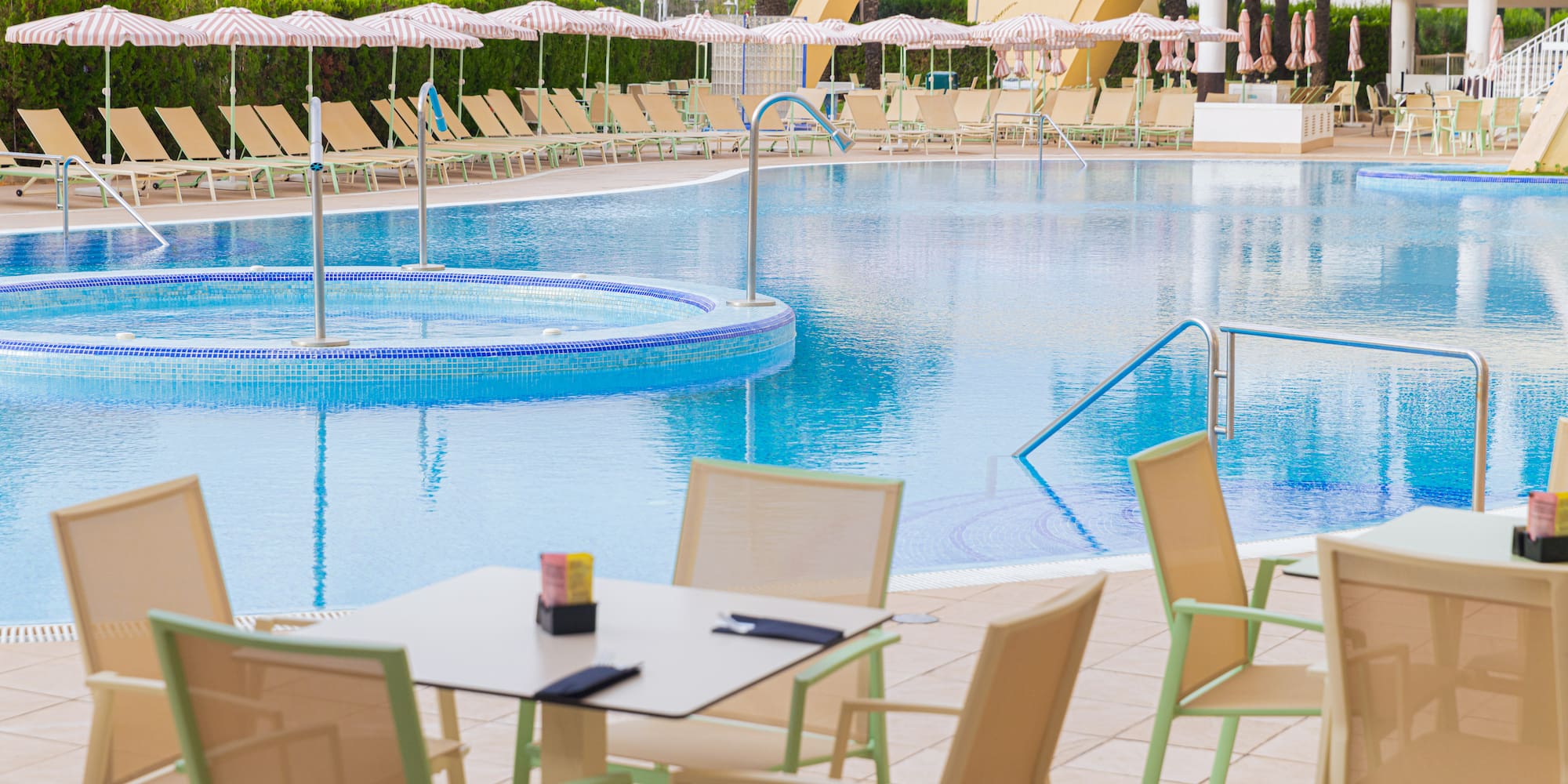 a pool with chairs and tables