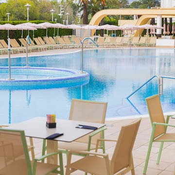a pool with chairs and tables