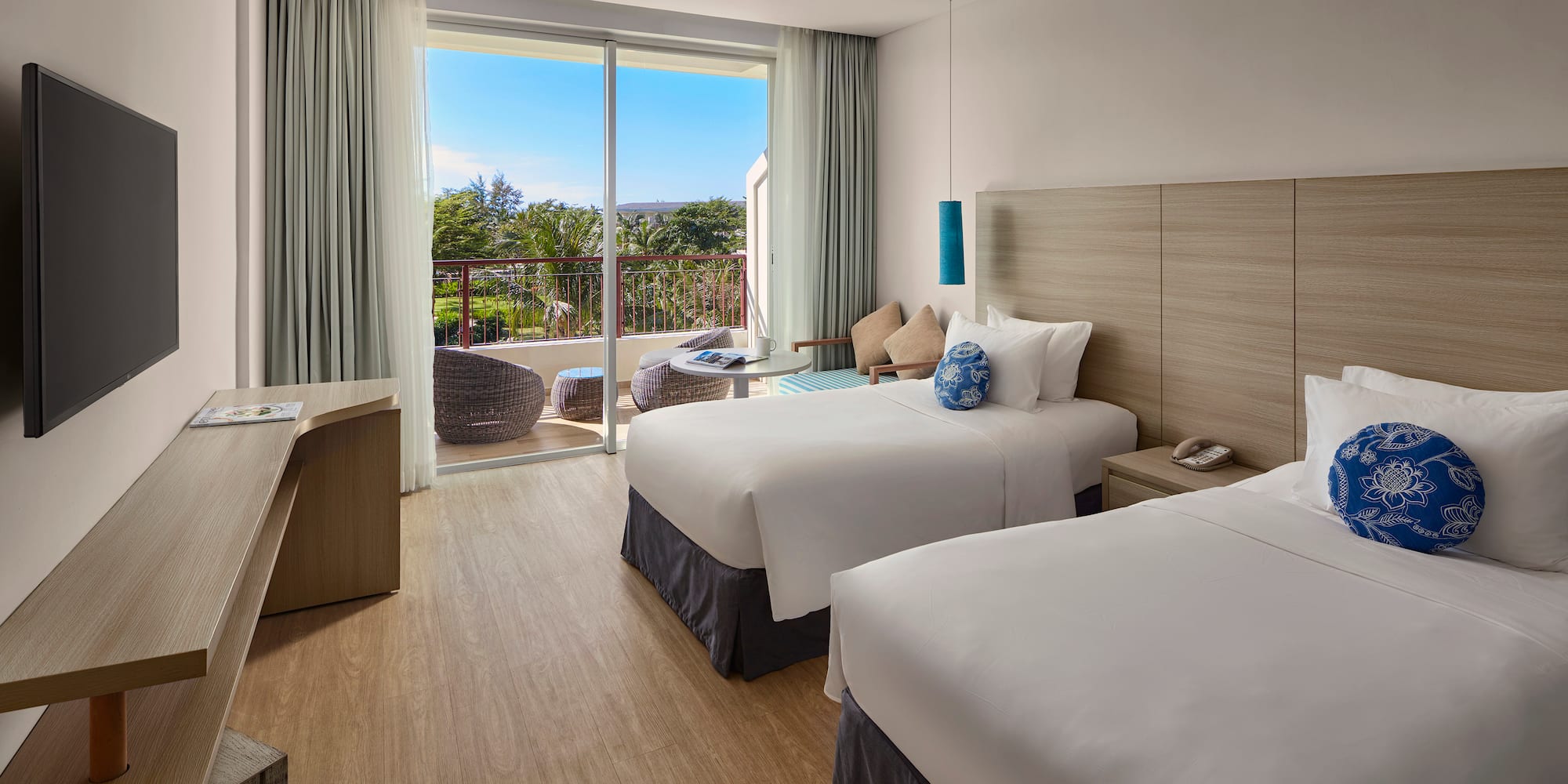 a room with two beds and a glass door