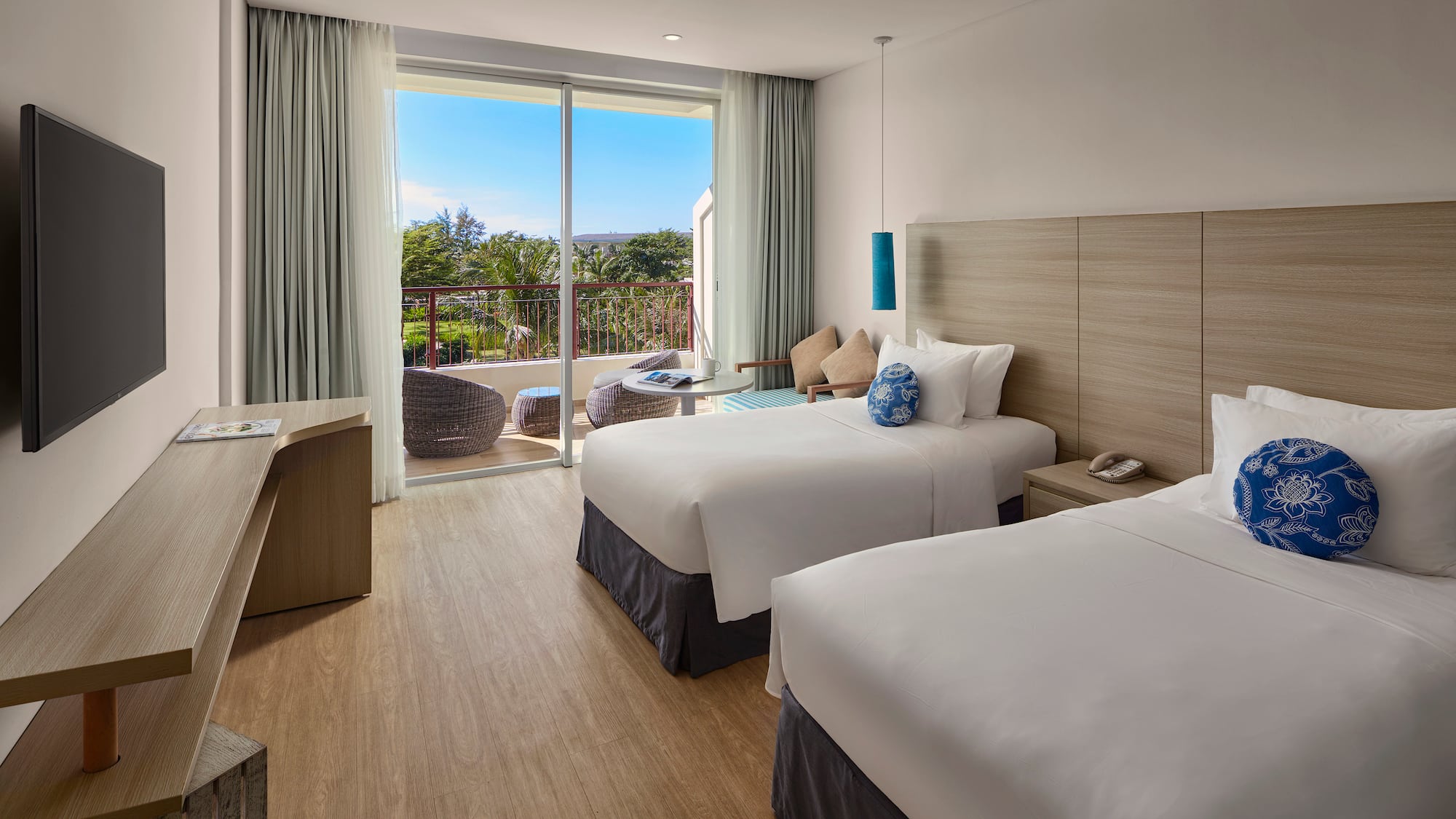 a room with two beds and a glass door