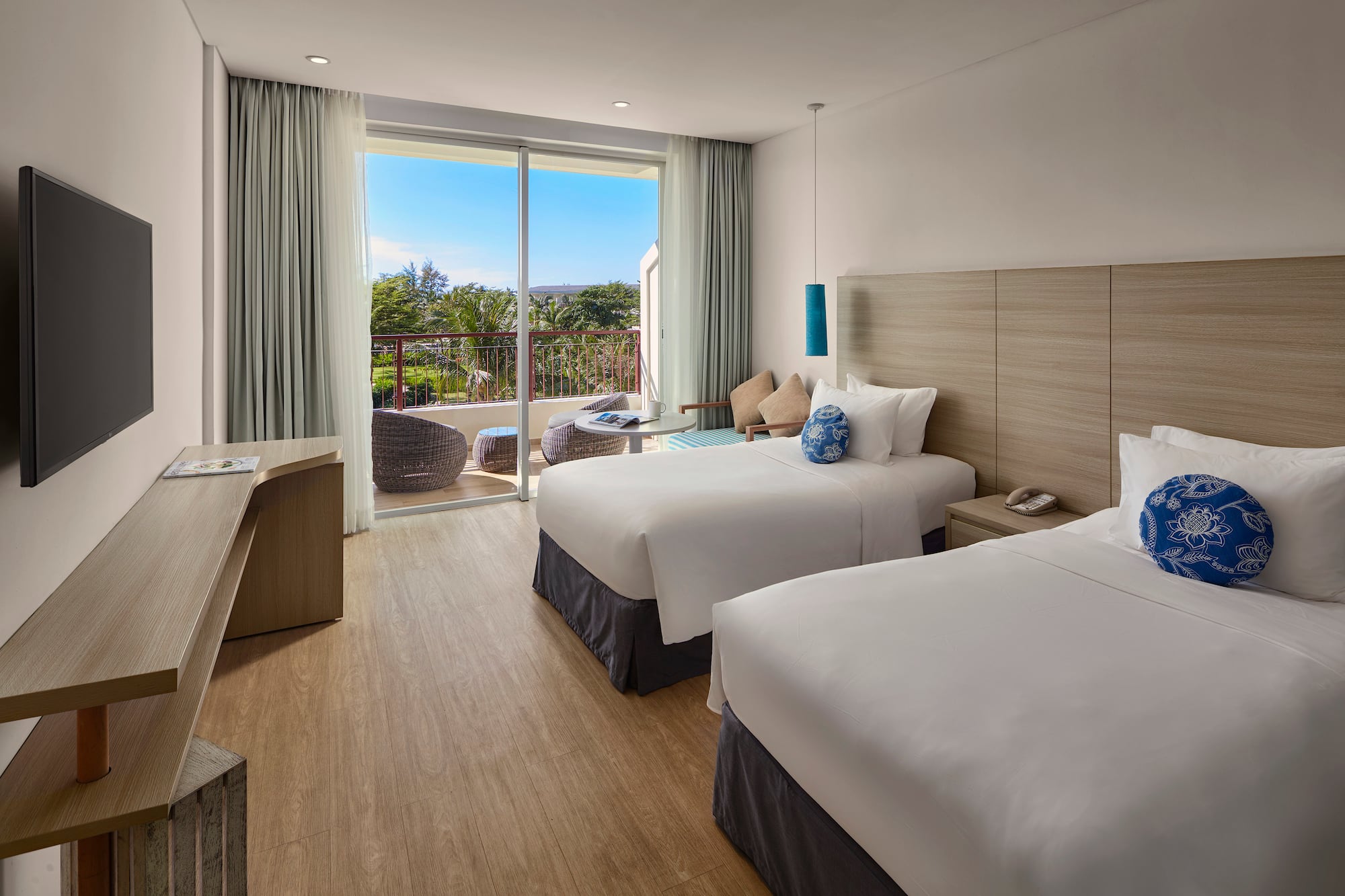 a room with two beds and a glass door