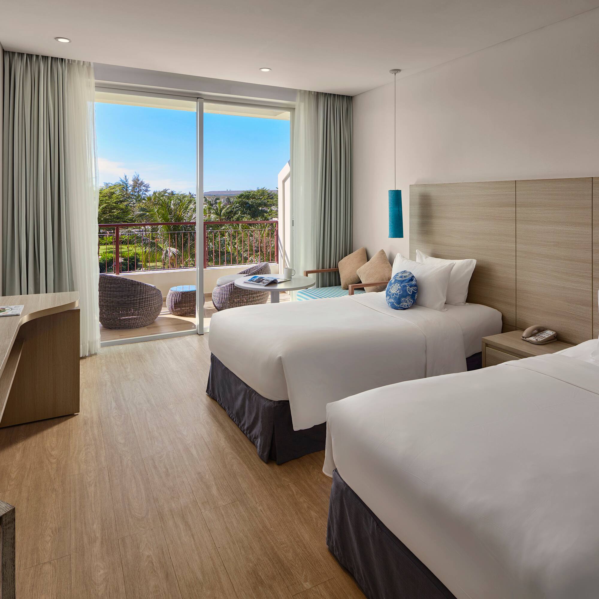 a room with two beds and a glass door