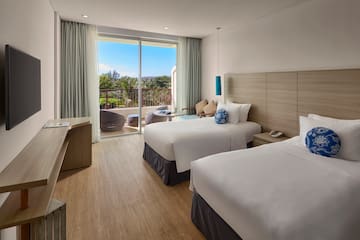 a room with two beds and a glass door