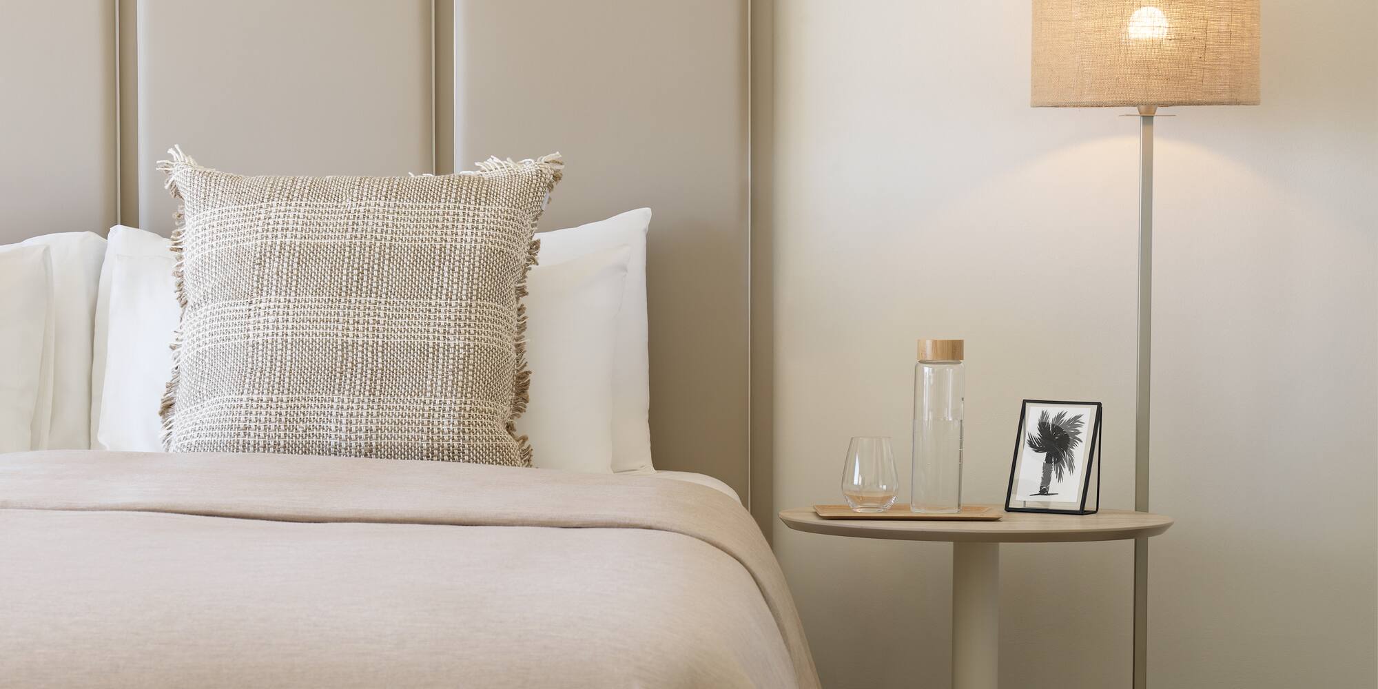 a bed with a lamp next to it