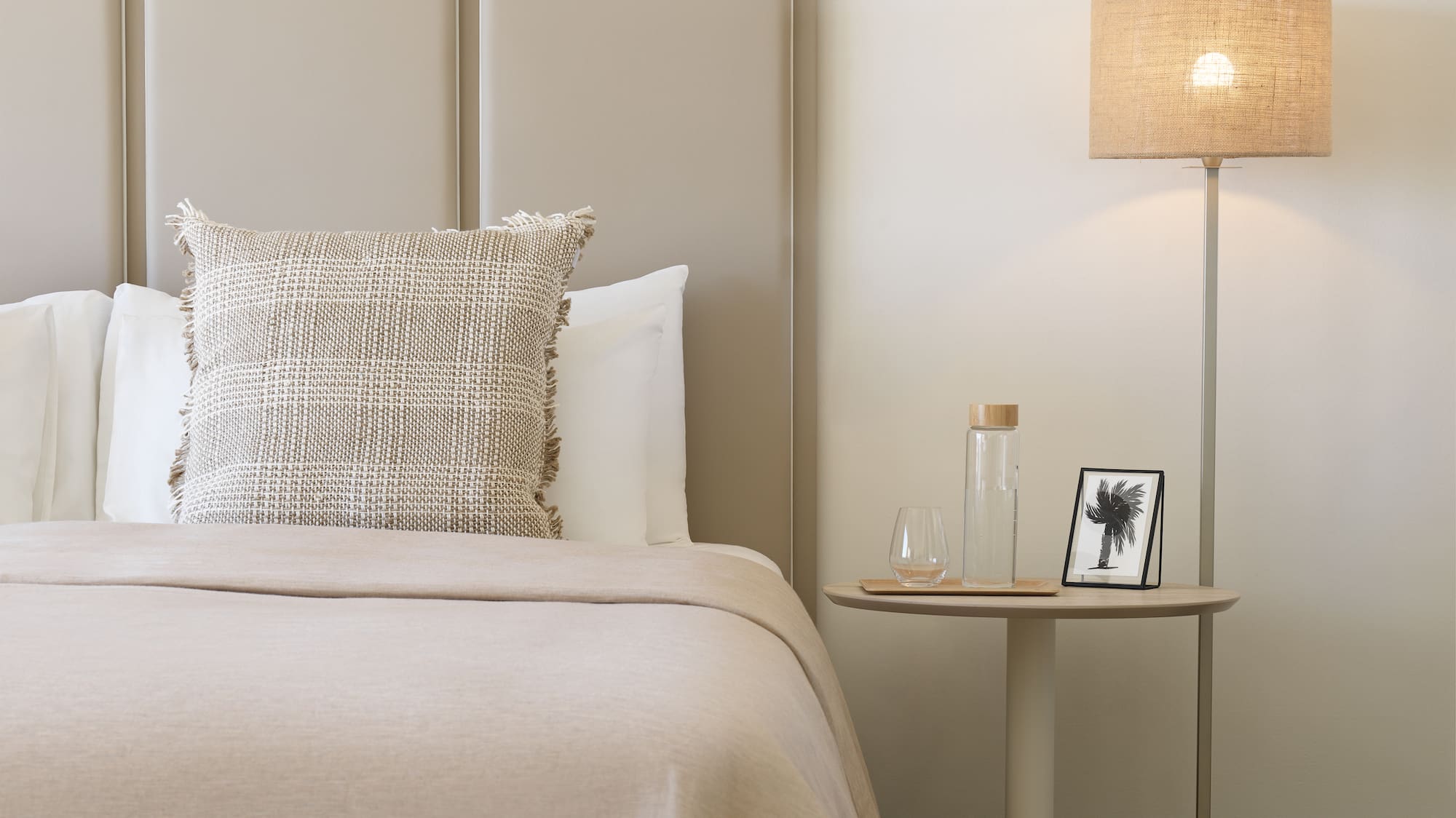 a bed with a lamp next to it