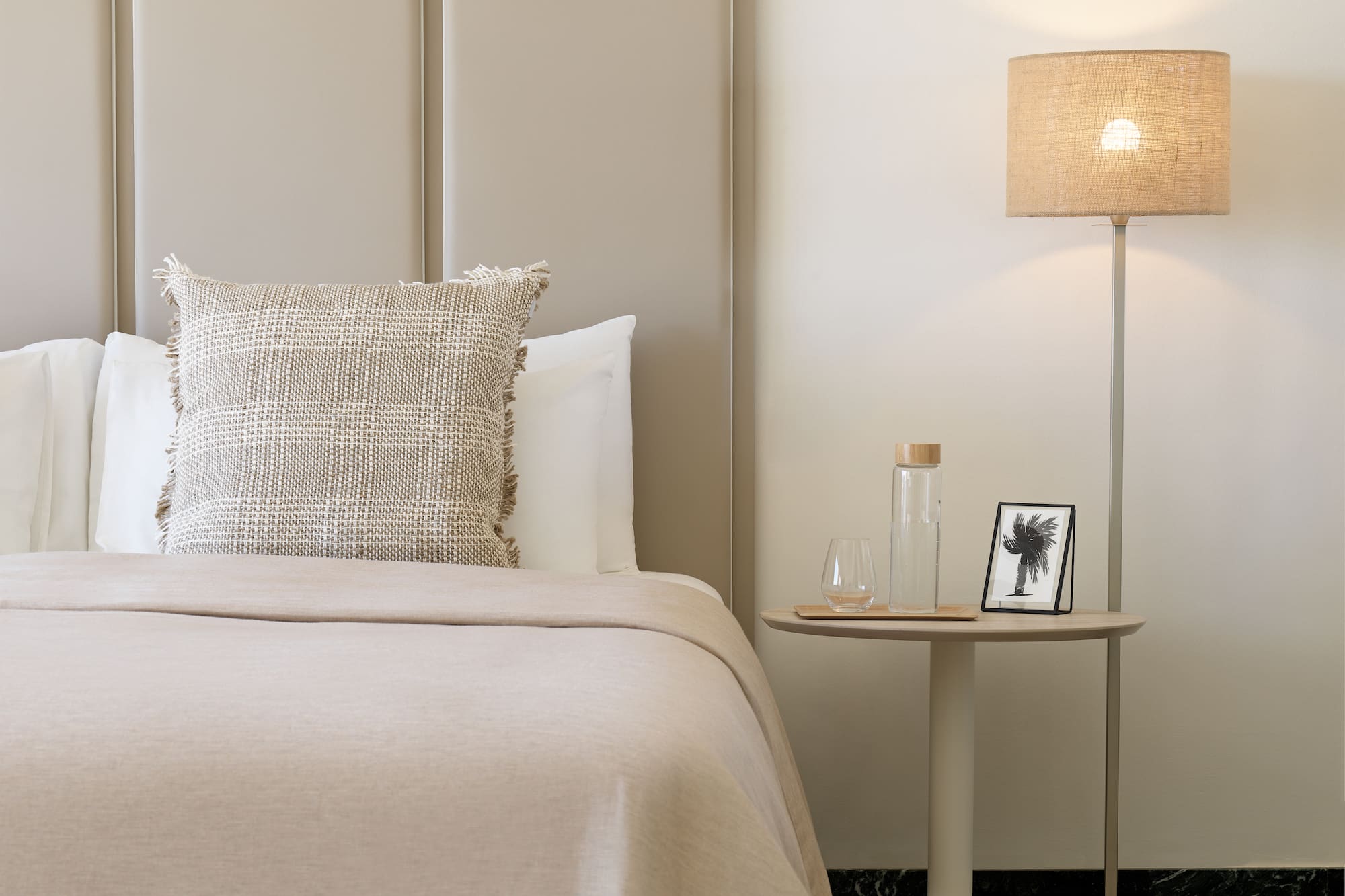 a bed with a lamp next to it