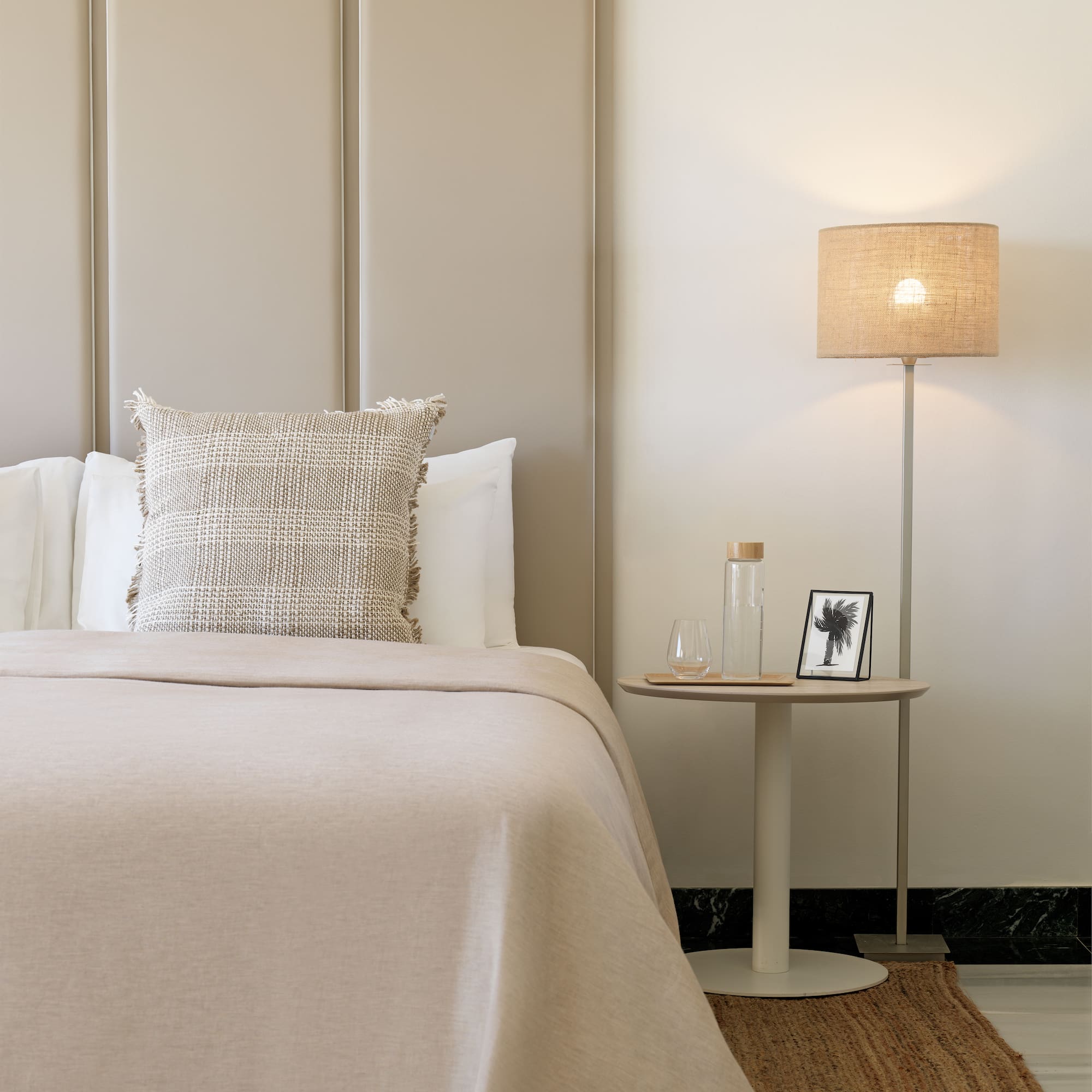 a bed with a lamp next to it