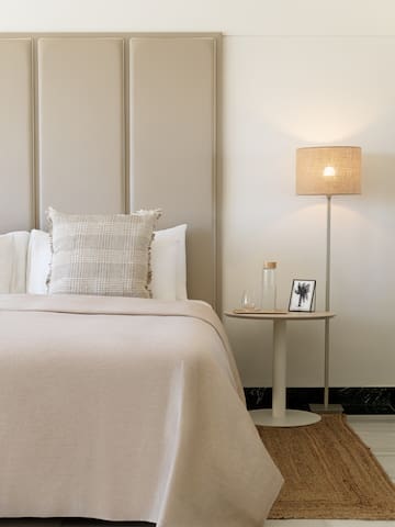 a bed with a lamp next to it