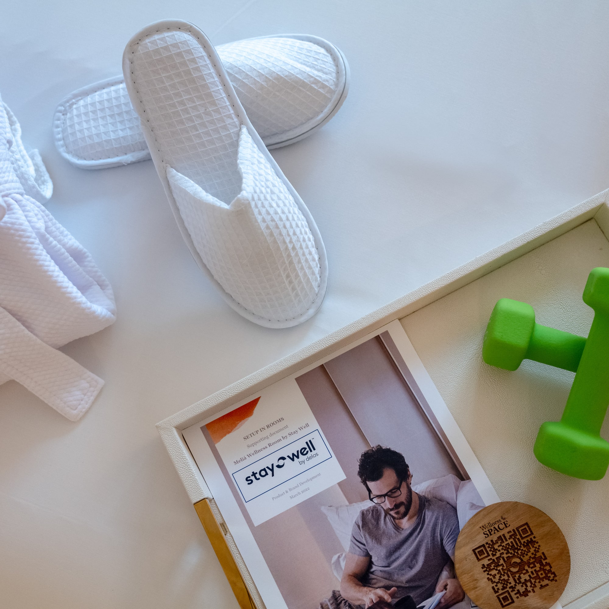 a pair of slippers and green dumbbells