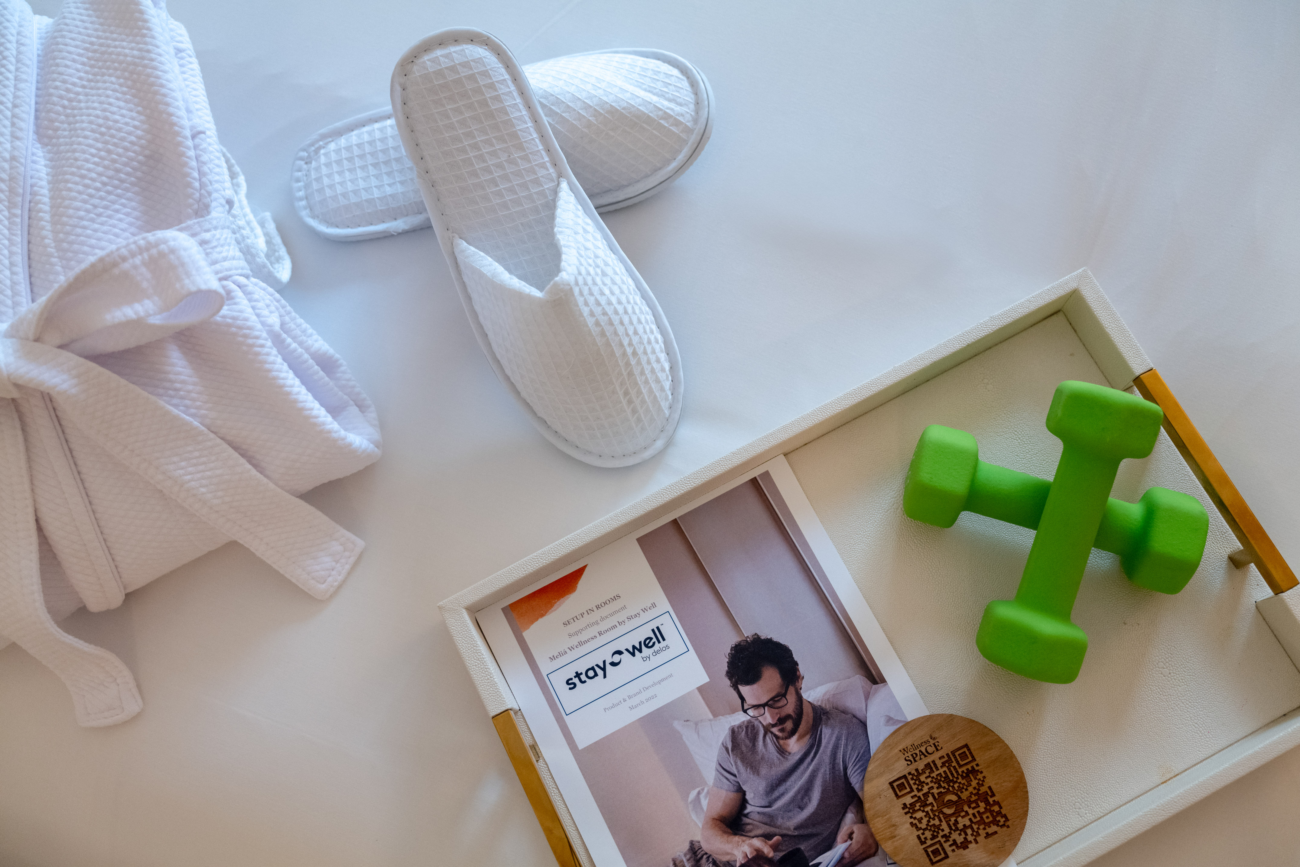 Hotel wellness room with bathrobe, slippers, dumbbells, and Stay Well guide. - The Level One Bedroom Suite - Meliá Orlando Celebration, Orlando