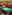 Classic pool hall with two billiard tables, wooden furniture, and warm lighting.