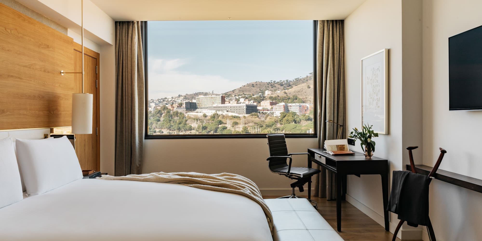 a bedroom with a large window and a bed