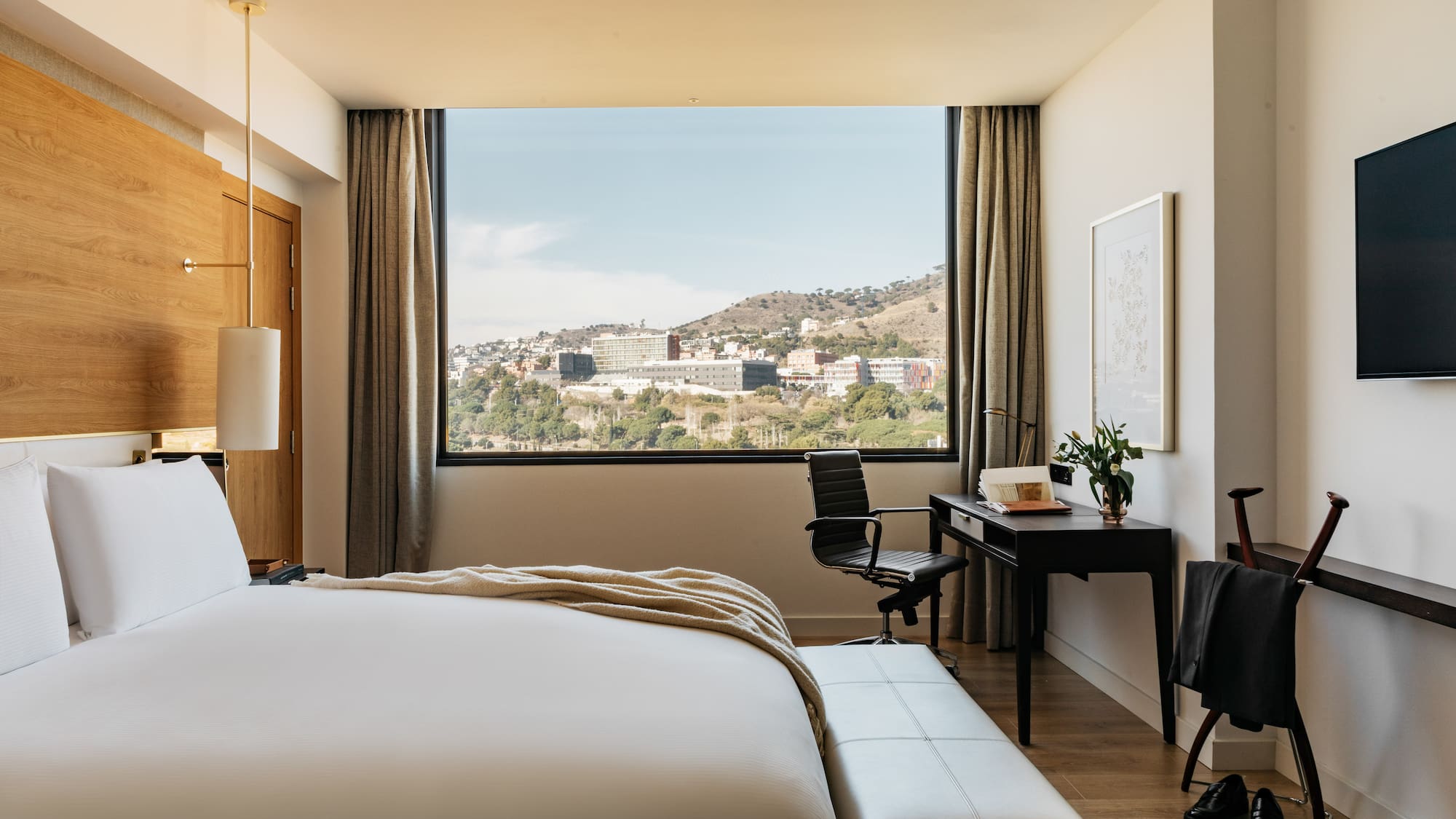 a bedroom with a large window and a bed