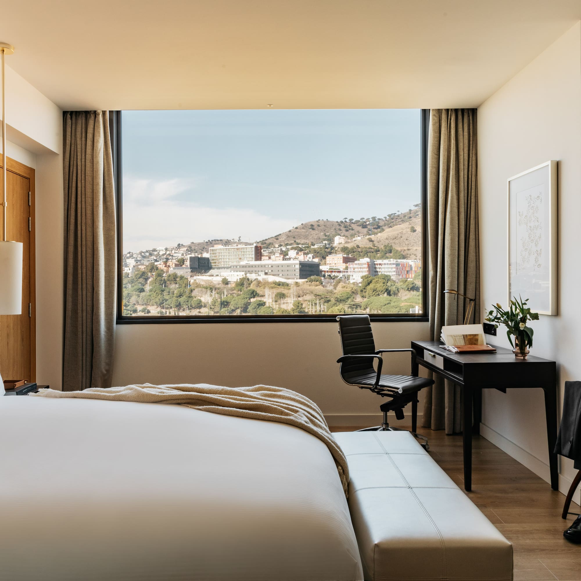 a bedroom with a desk and a bed