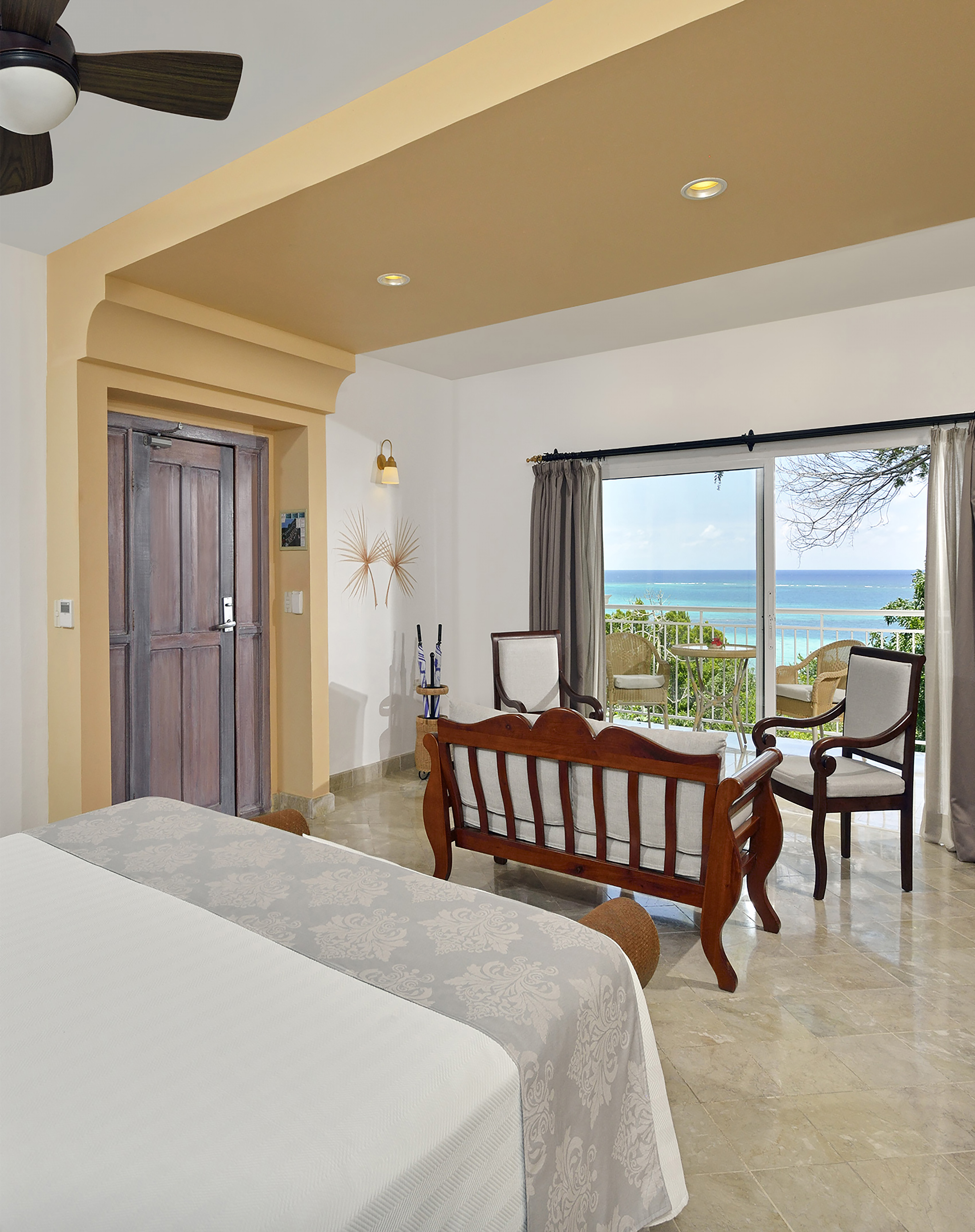 a room with a bed and a chair and a door