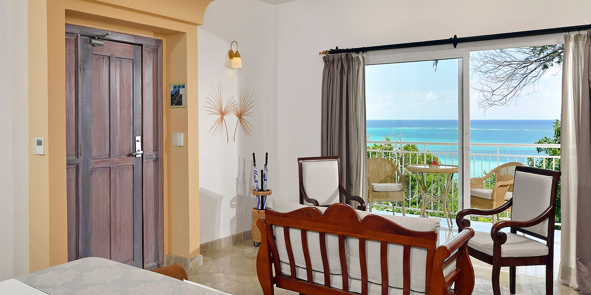 a room with a bed and a chair and a door