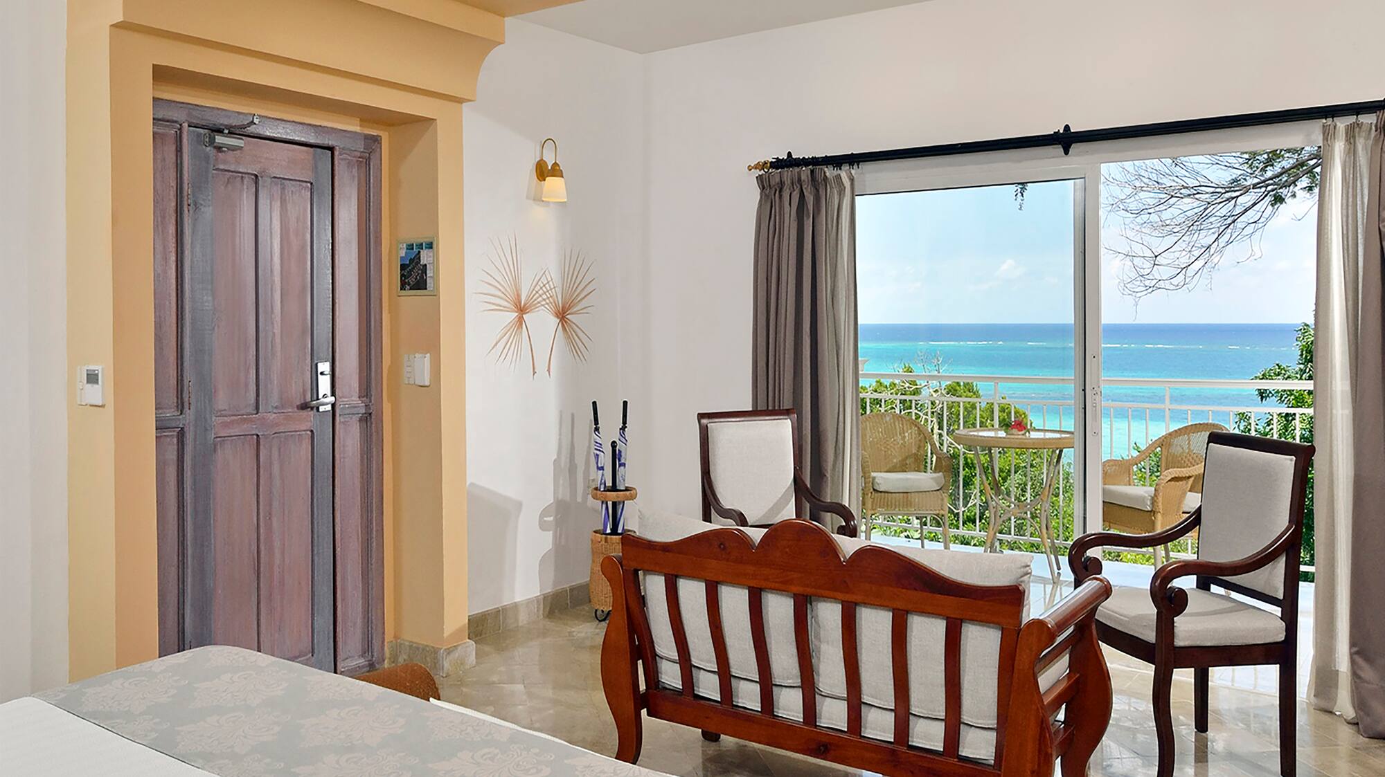 a room with a bed and a chair and a door