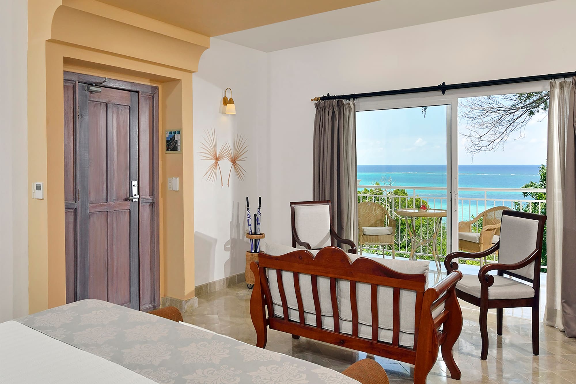 a room with a bed and a chair and a door