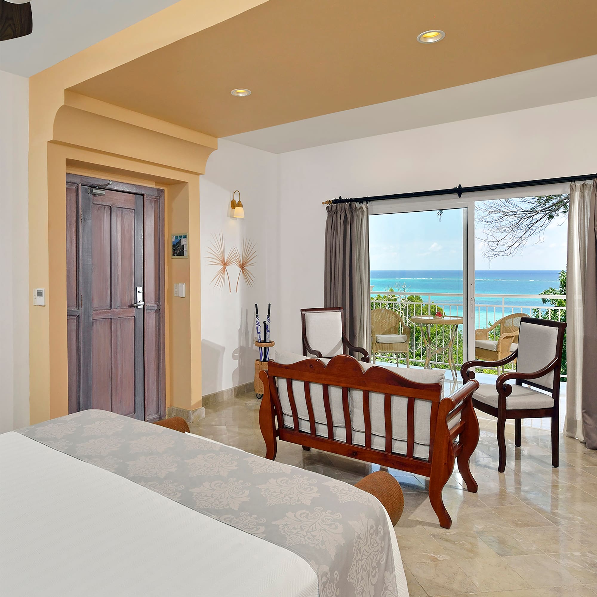 a room with a bed and a chair and a door