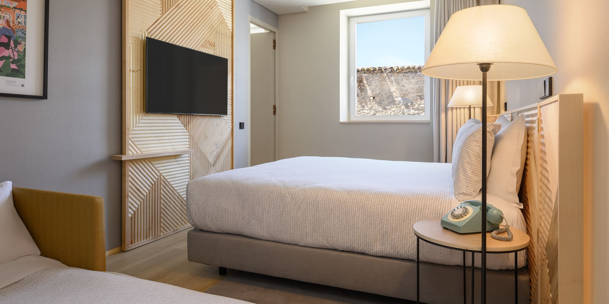 a bedroom with a television and a bed