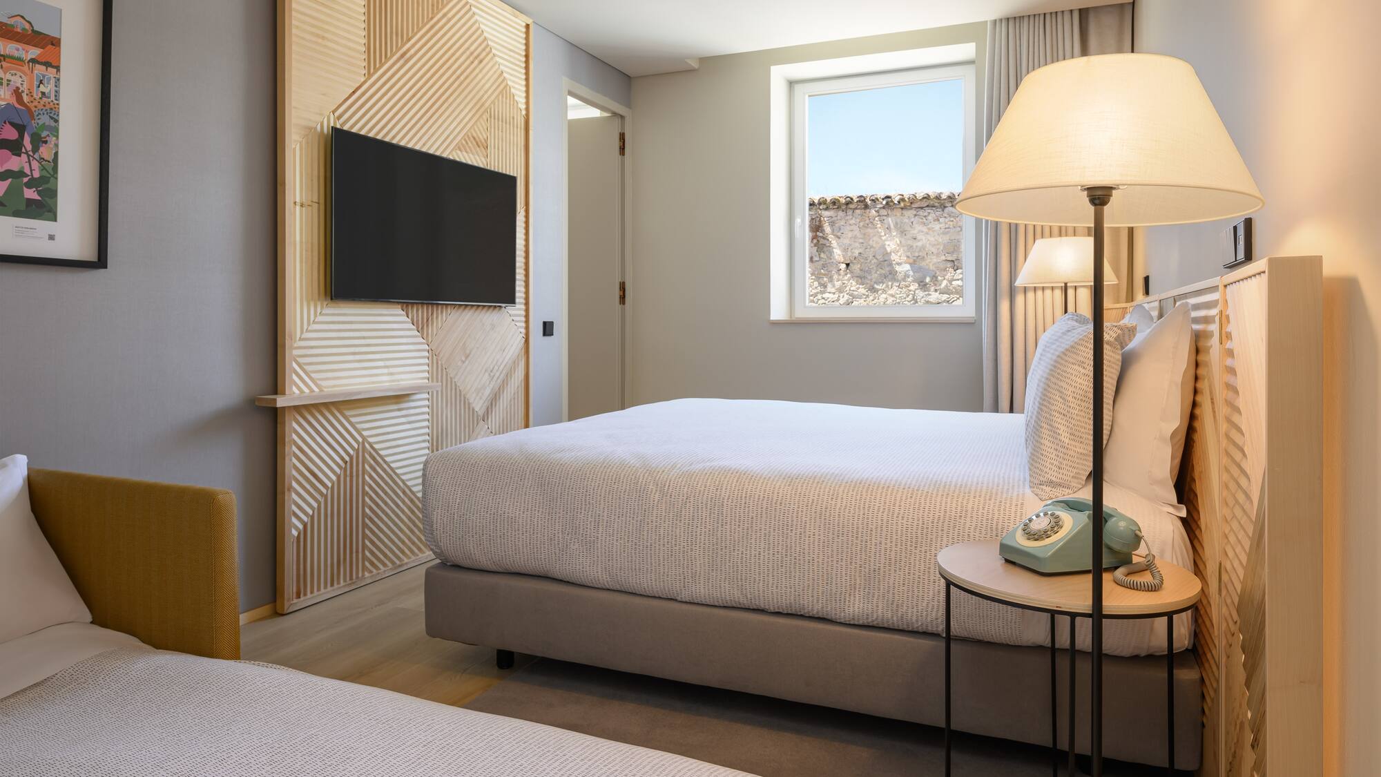 a bedroom with a television and a bed