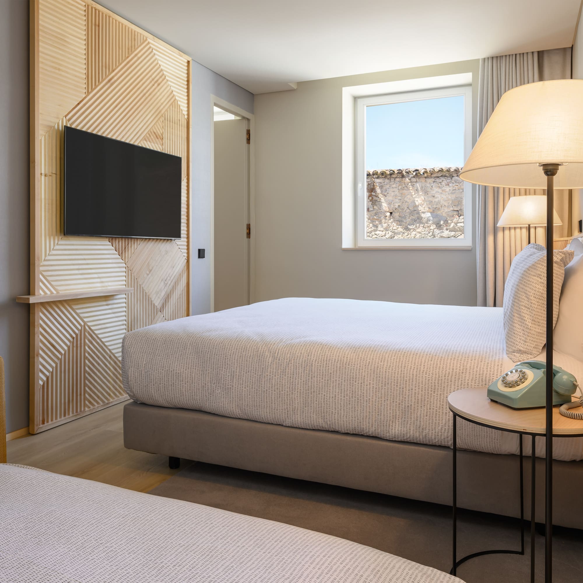 a bedroom with a television and a bed