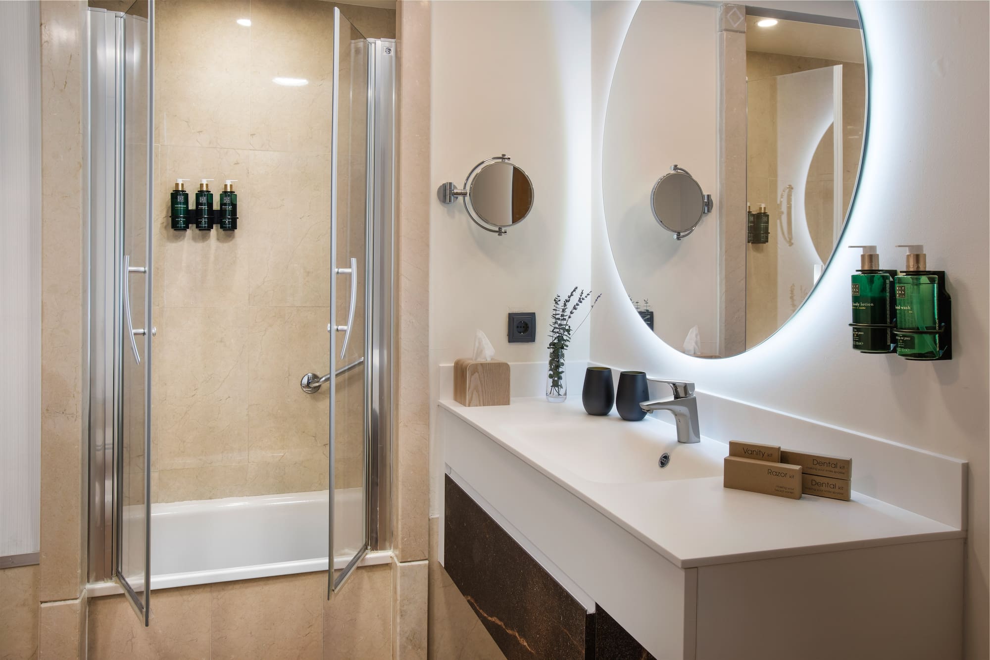 a bathroom with a round mirror and a shower