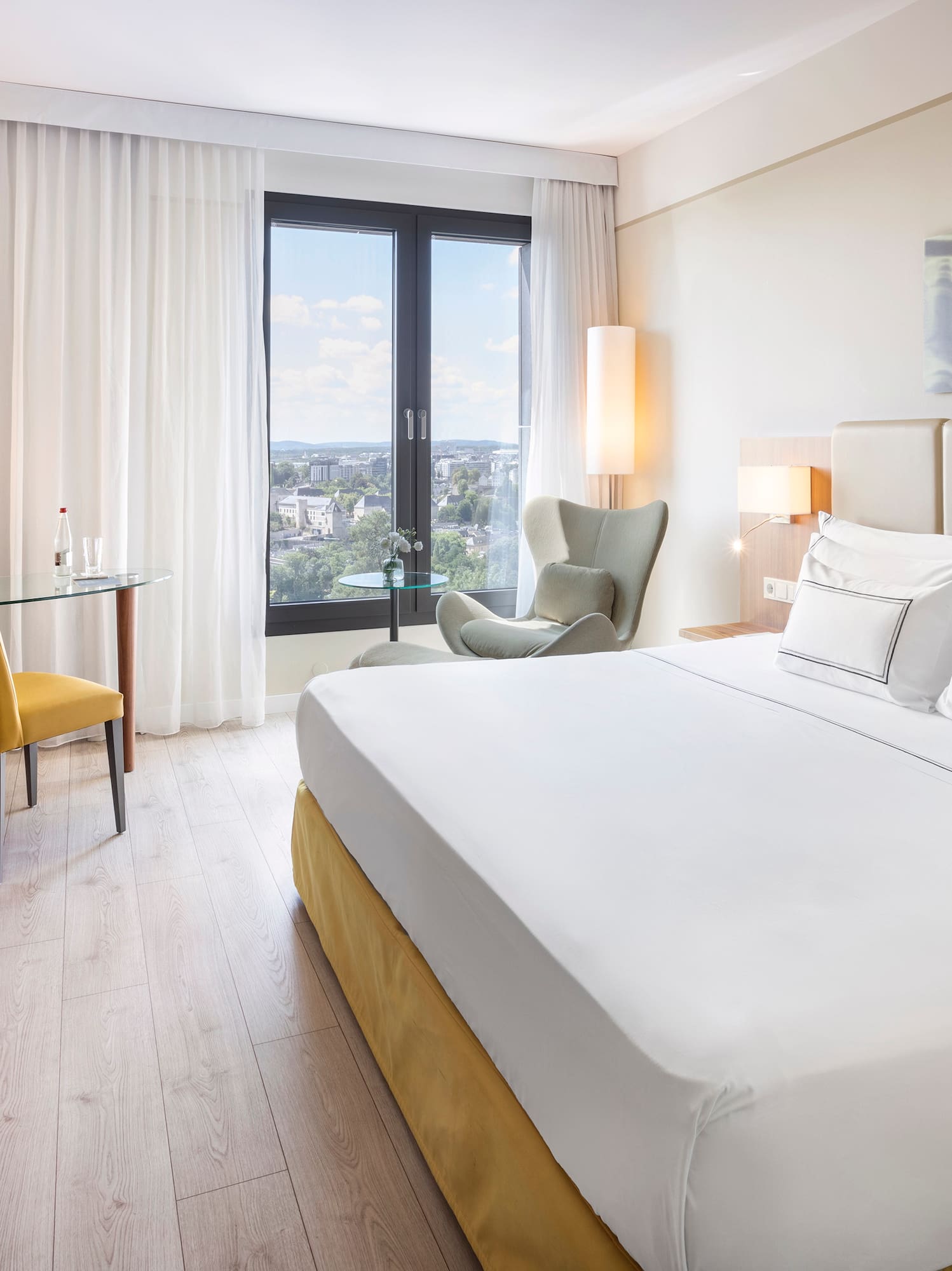 a room with a bed and a desk and chair