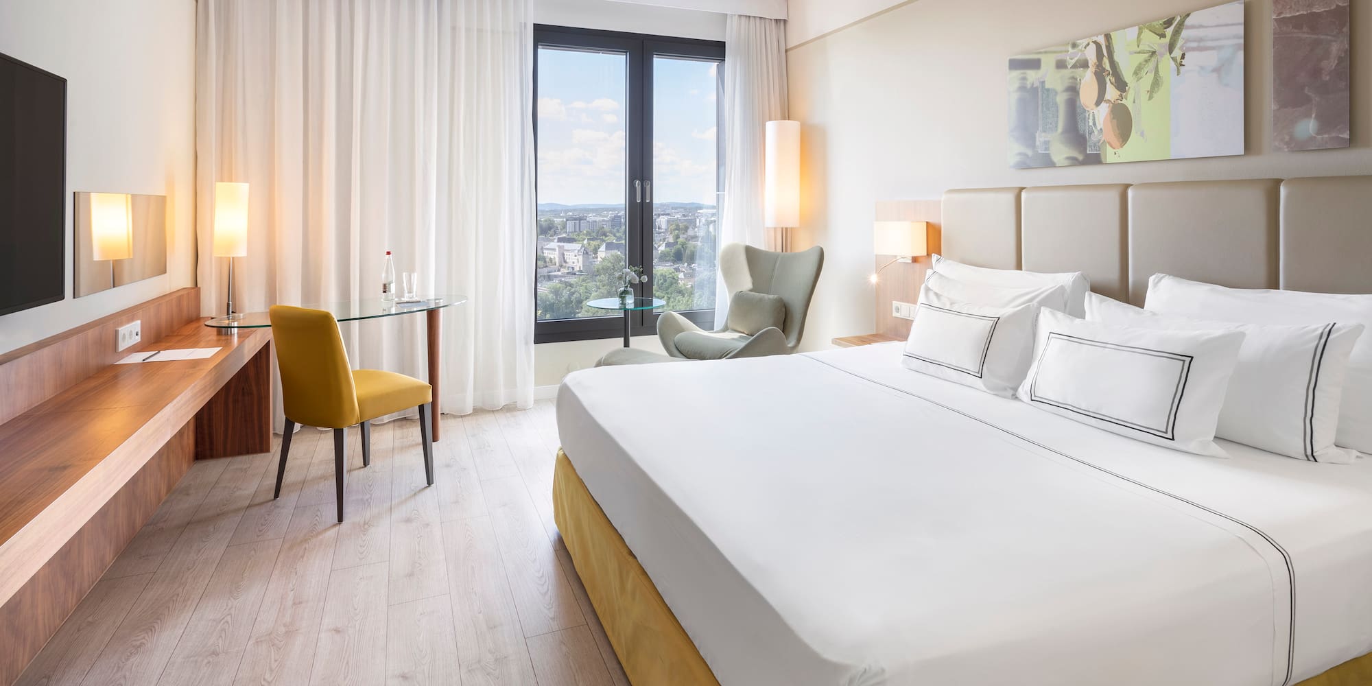 a room with a bed and a desk and chair